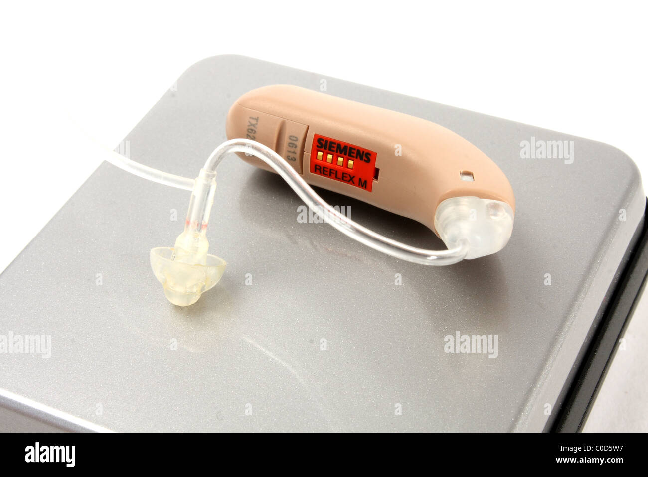 A digital hearing aid by Siemens for a NHS hearing aid fitting. Including an ear mold and box. Stock Photo