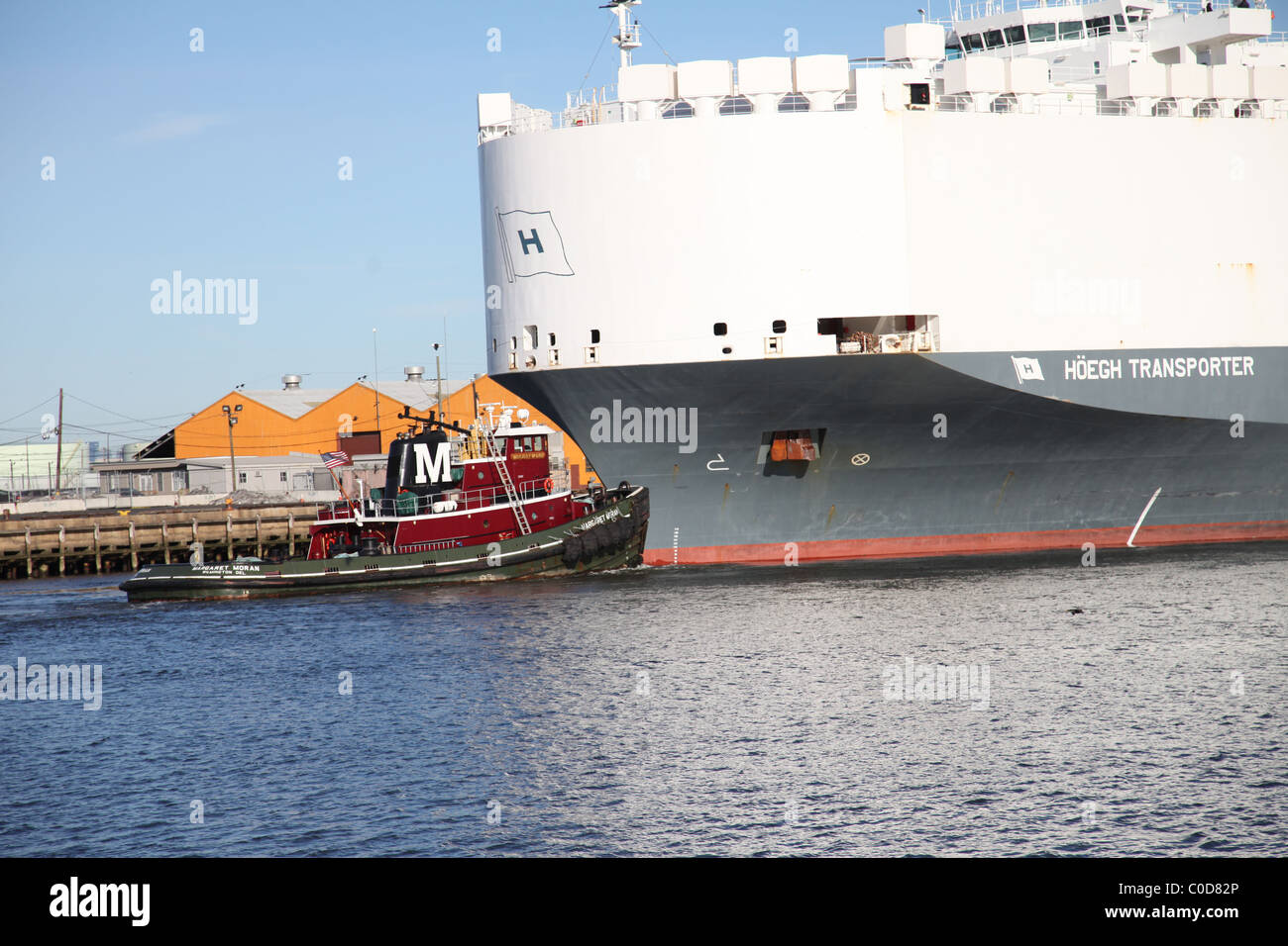 Tugboat Moran at Port Newark, NJ USA, United States of America pushing Hoegh Transporter Autoliner out to Atlantic Ocean Stock Photo