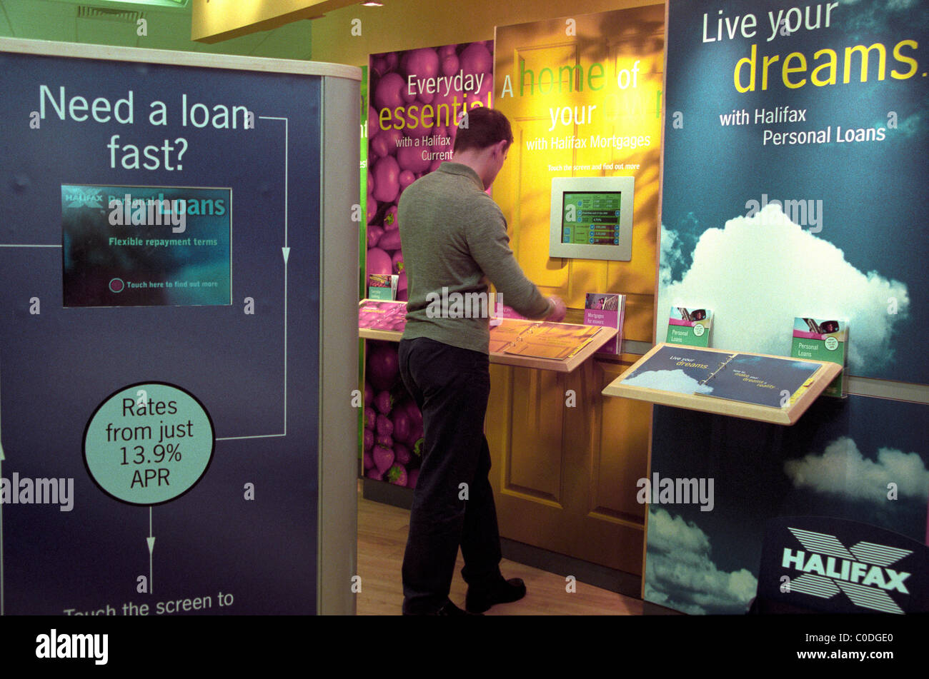 A Man In The Halifax Building Society Using A Touch Screen To