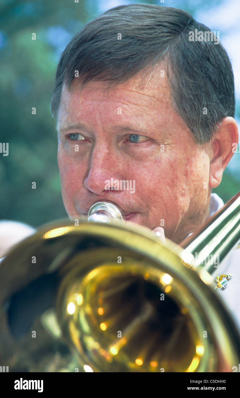 Trombone player, in the New Horizon Band, playing in outdoor concert at