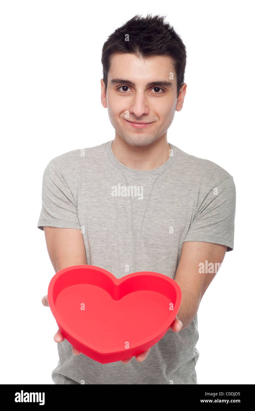 lovely portrait of a young man holding a red heart (isolated on white ...