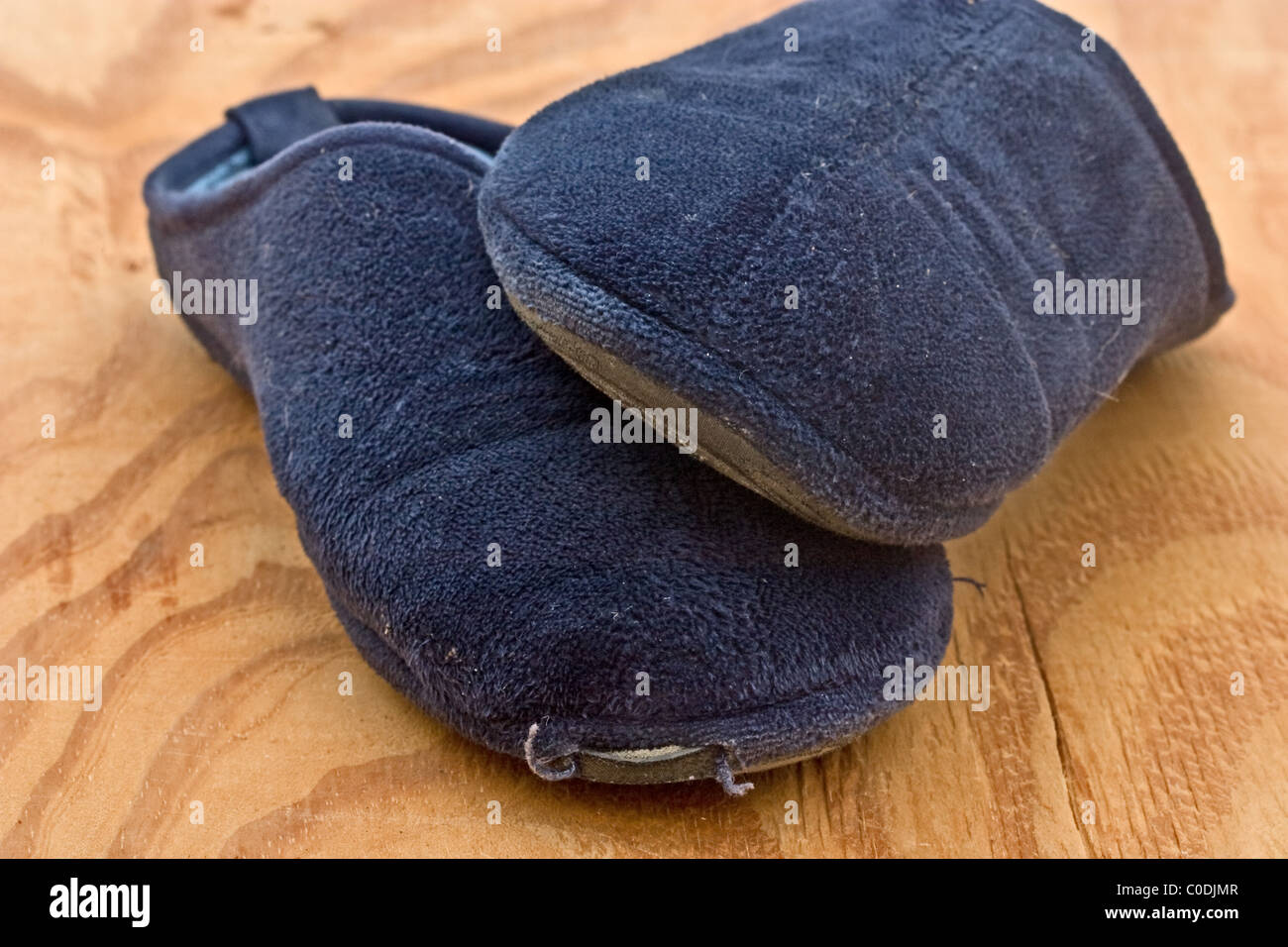 Old frayed blue bedroom slippers Stock Photo