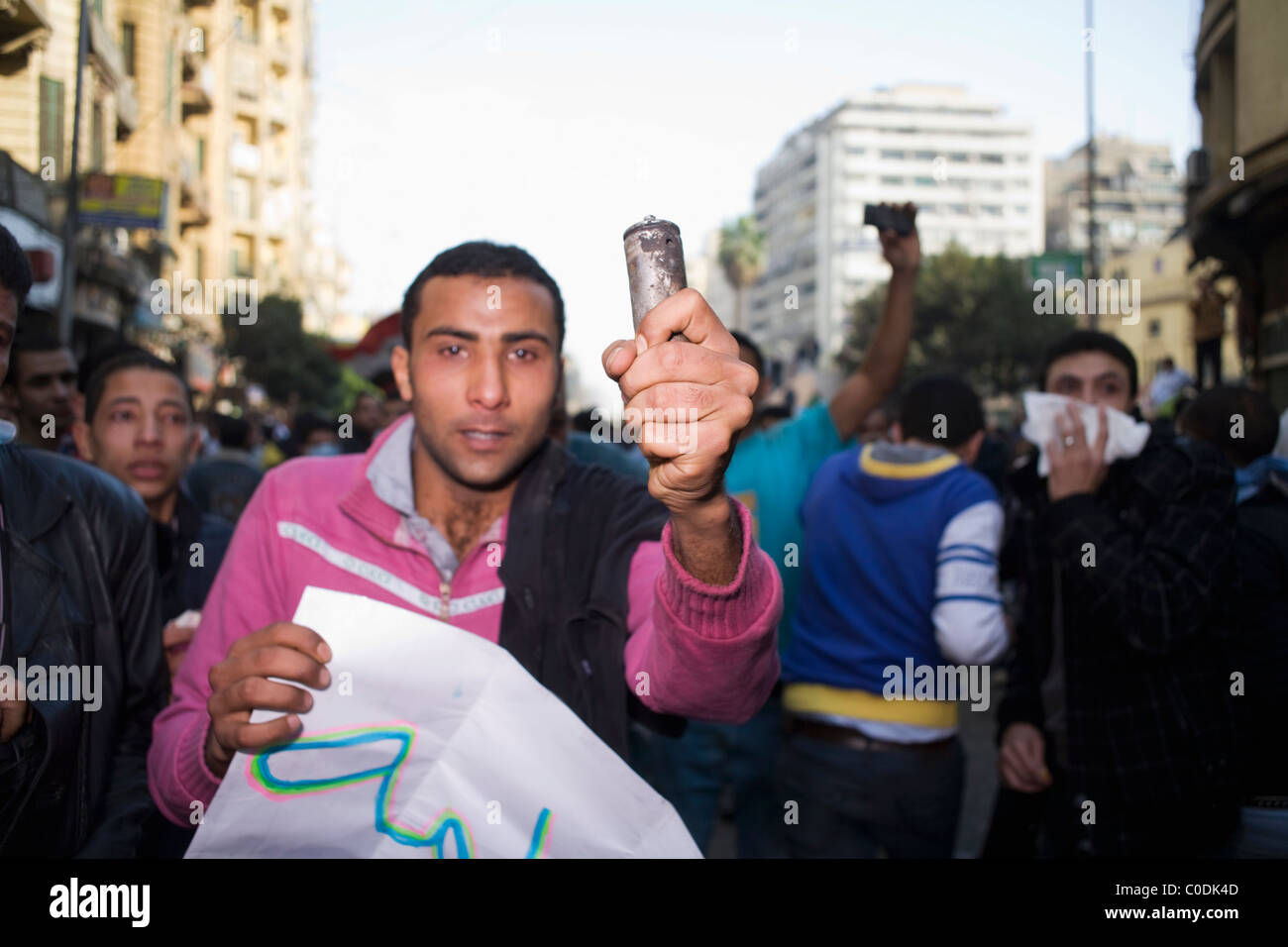 A man holds up a tear gas canister during the street protests in downtown Cairo, Egypt on 'Angry Friday', Jan.28, 2011 Stock Photo