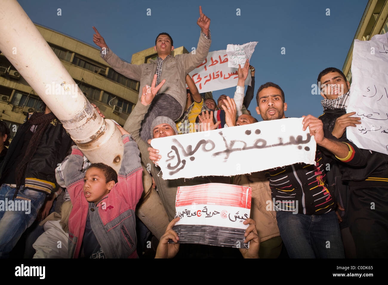 Protesters crowd atop a tank during the anti-government occupation of Tahrir Square in downtown Cairo, Egypt on Jan.29, 2011 Stock Photo