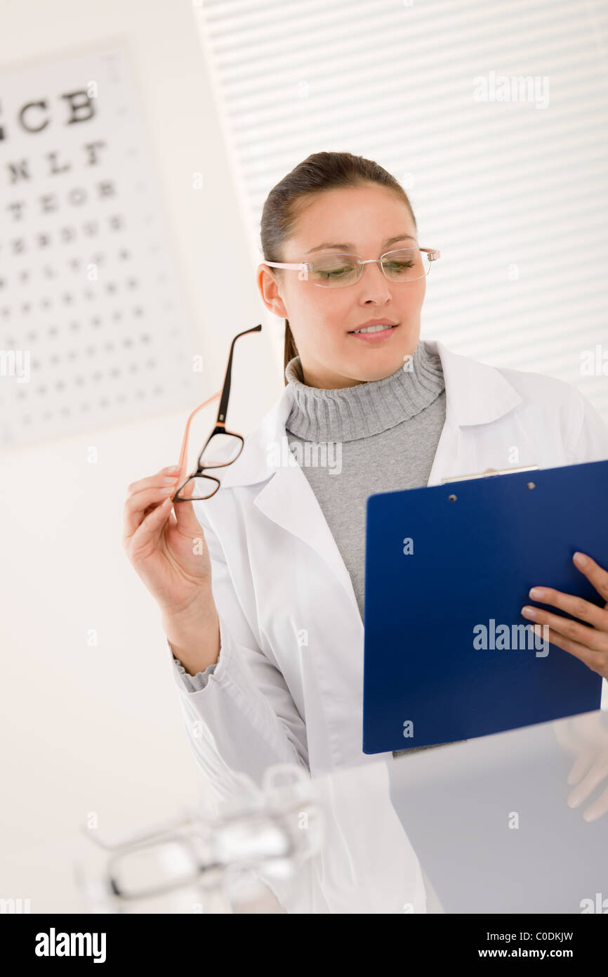 Optician doctor woman with prescription glasses and eye chart Stock