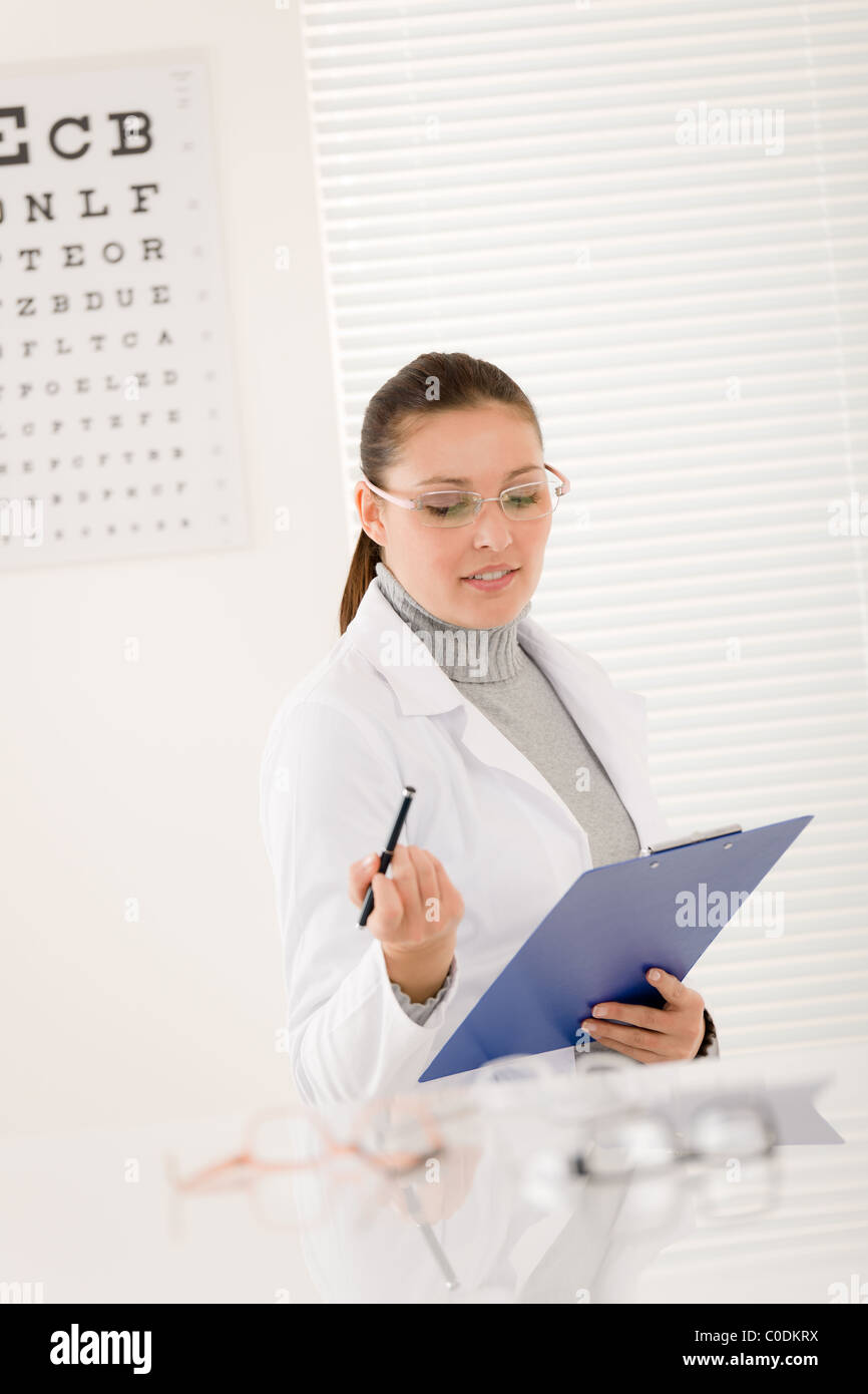 Optician doctor woman with prescription glasses and eye chart Stock
