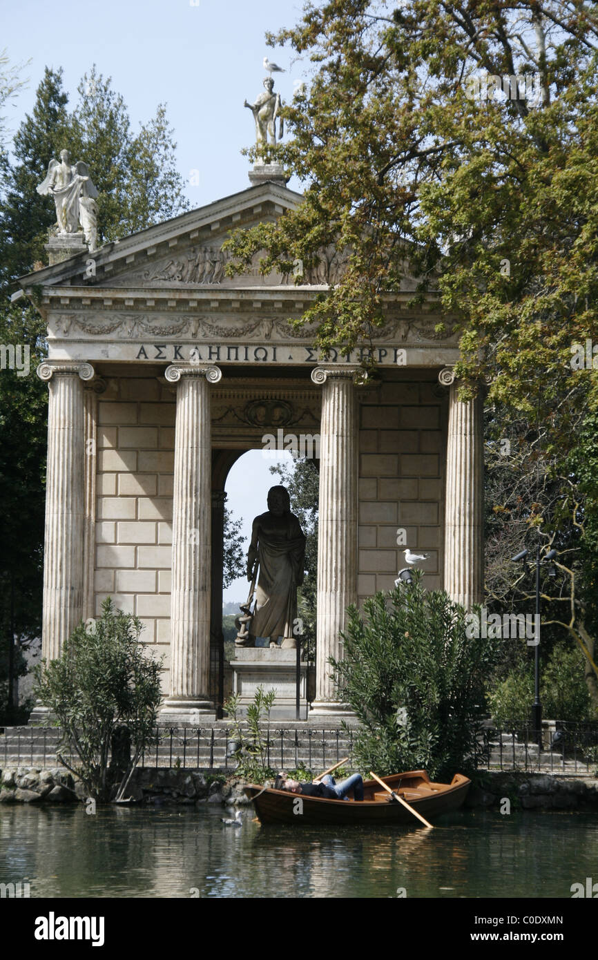 young couple in rowing boat on lake in villa park in rome