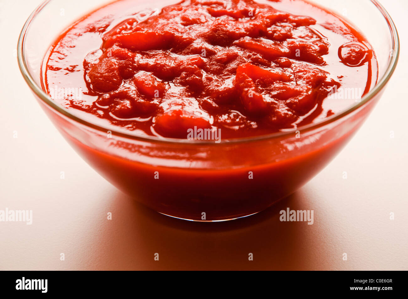 Chopped ( tinned ) tomatoes in a glass bowl. Stock Photo