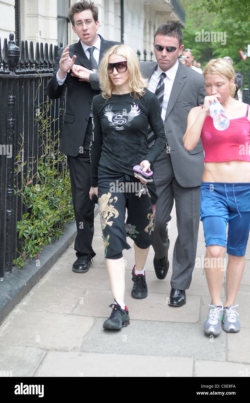 Madonna leaving her gym with her personal trainer. A journalist