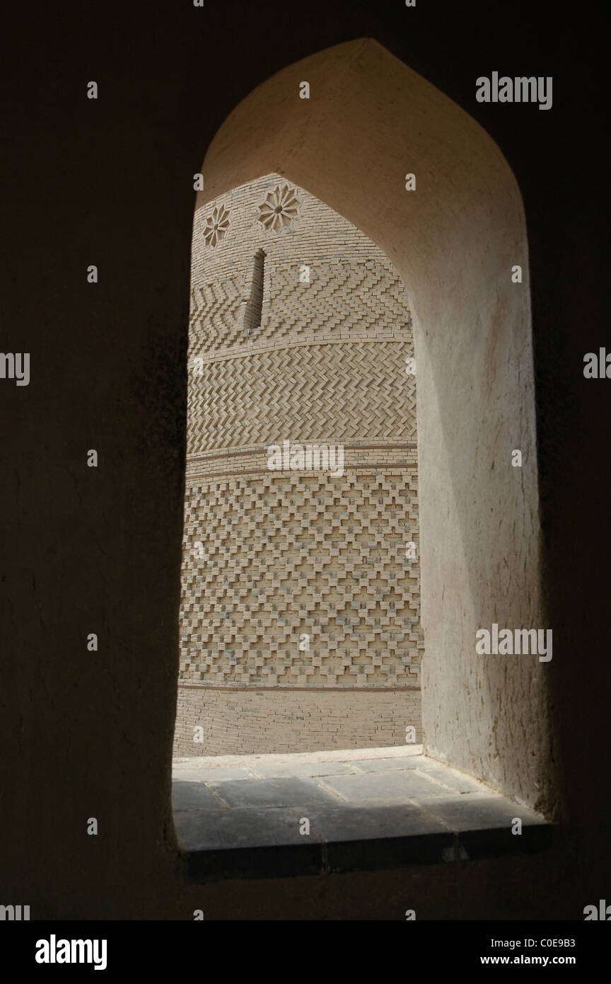 View of intricate brickwork of Emin mosque, Turpan, through a stone window Stock Photo
