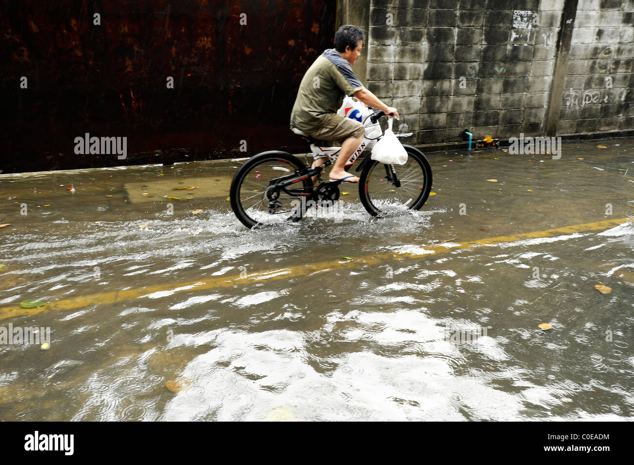 a rainy day in bangkok ( crazy flooded street), everyday life in the big mango, strange weather situation Stock Photo