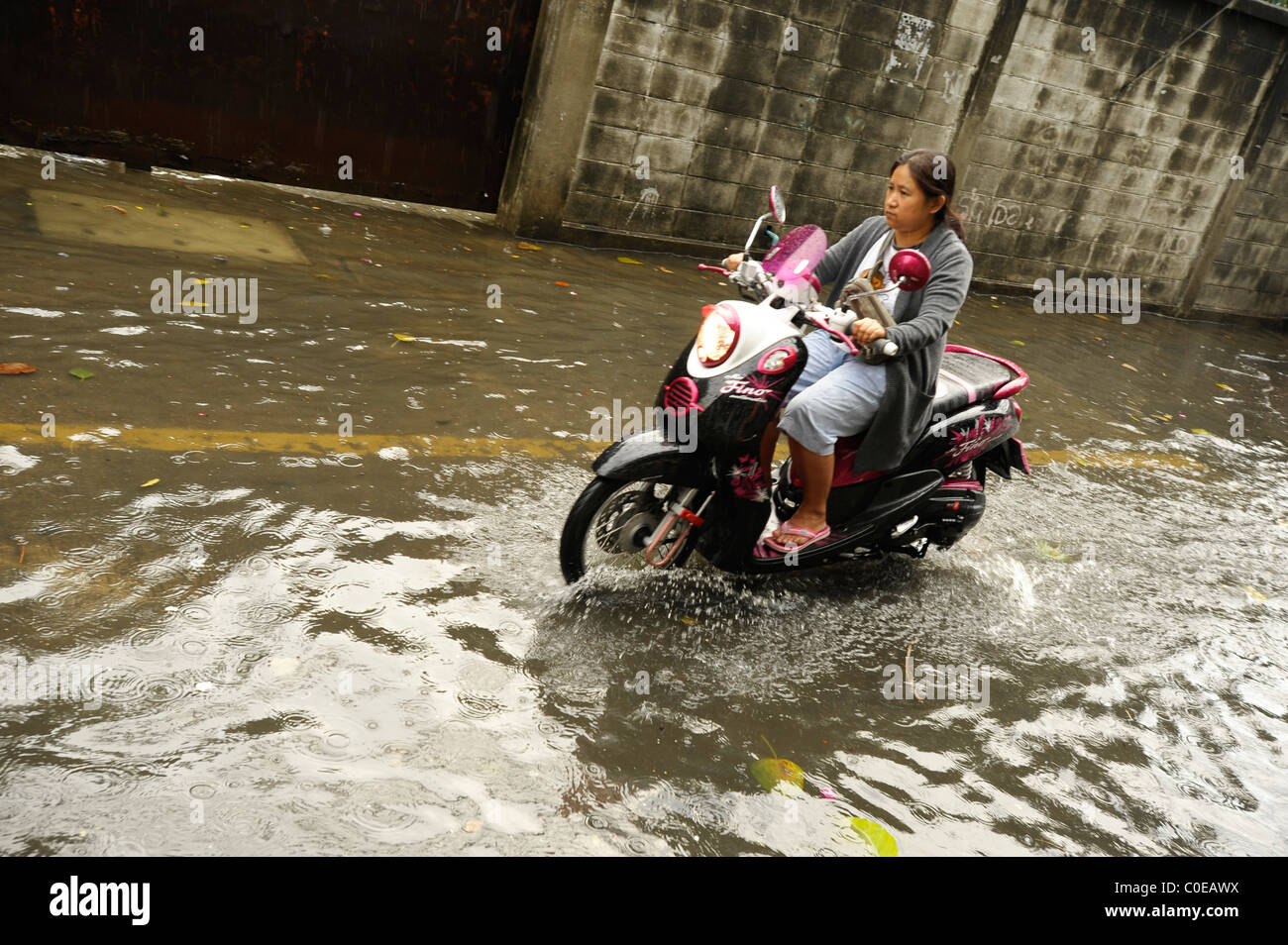 a rainy day in bangkok ( crazy flooded street), everyday life in the big mango, strange weather situation Stock Photo
