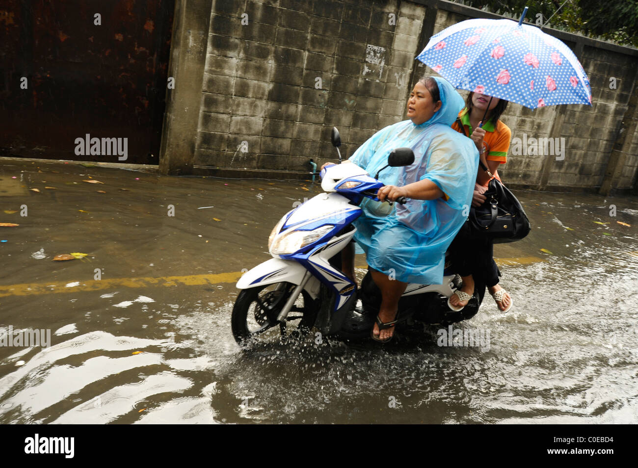a rainy day in bangkok ( crazy flooded street), everyday life in the big mango, strange weather situation Stock Photo