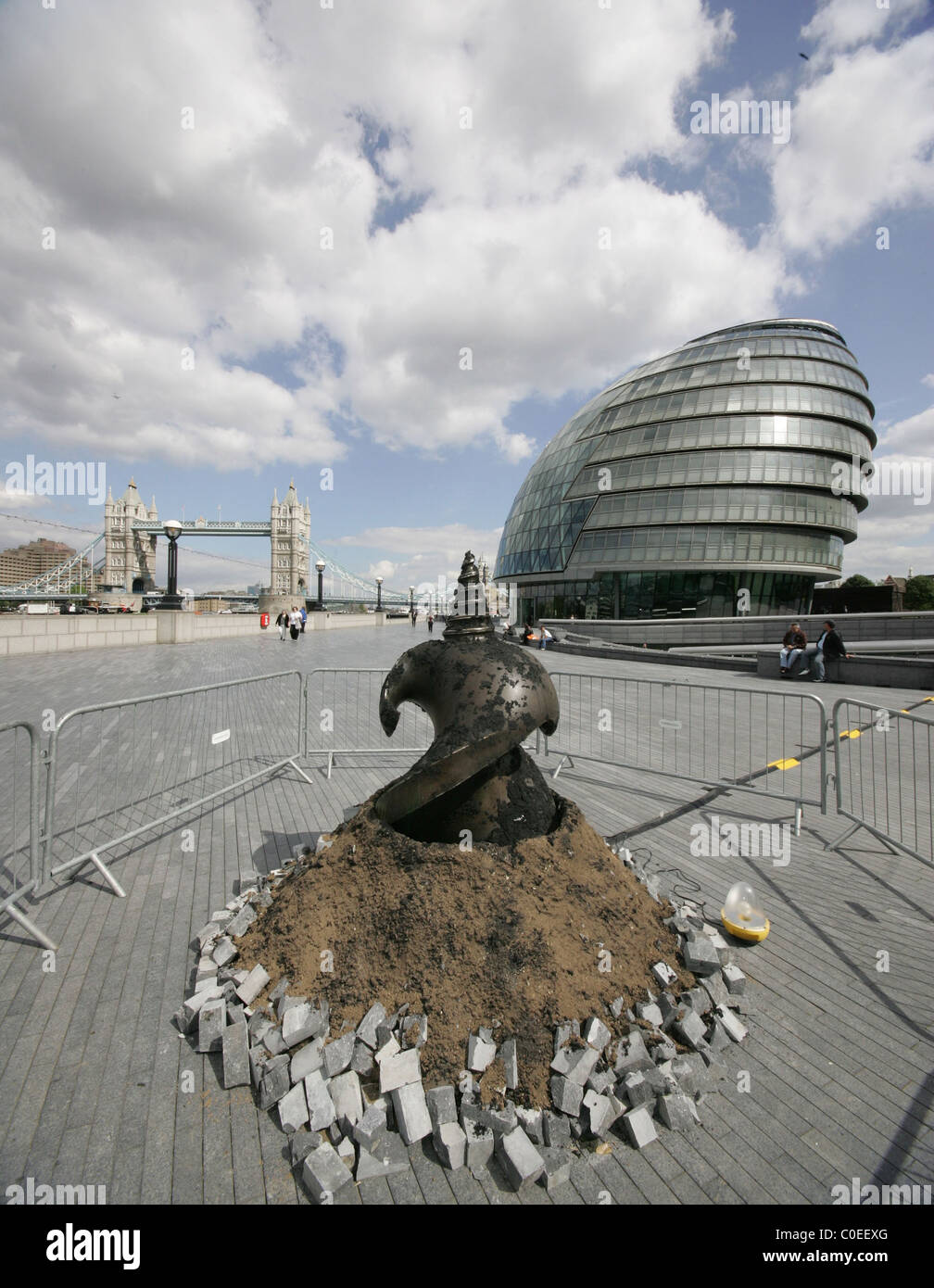 A Giant Drill Bit Surfaces Through The Paving Stones On The Walkway At The Foot Of Tower Bridge As Part Of An Art Installation A Giant Drill Bit Surfaces Through The Paving Stones On The Walkway At The Foot Of Tower Bridge As Part Of An Art Installation