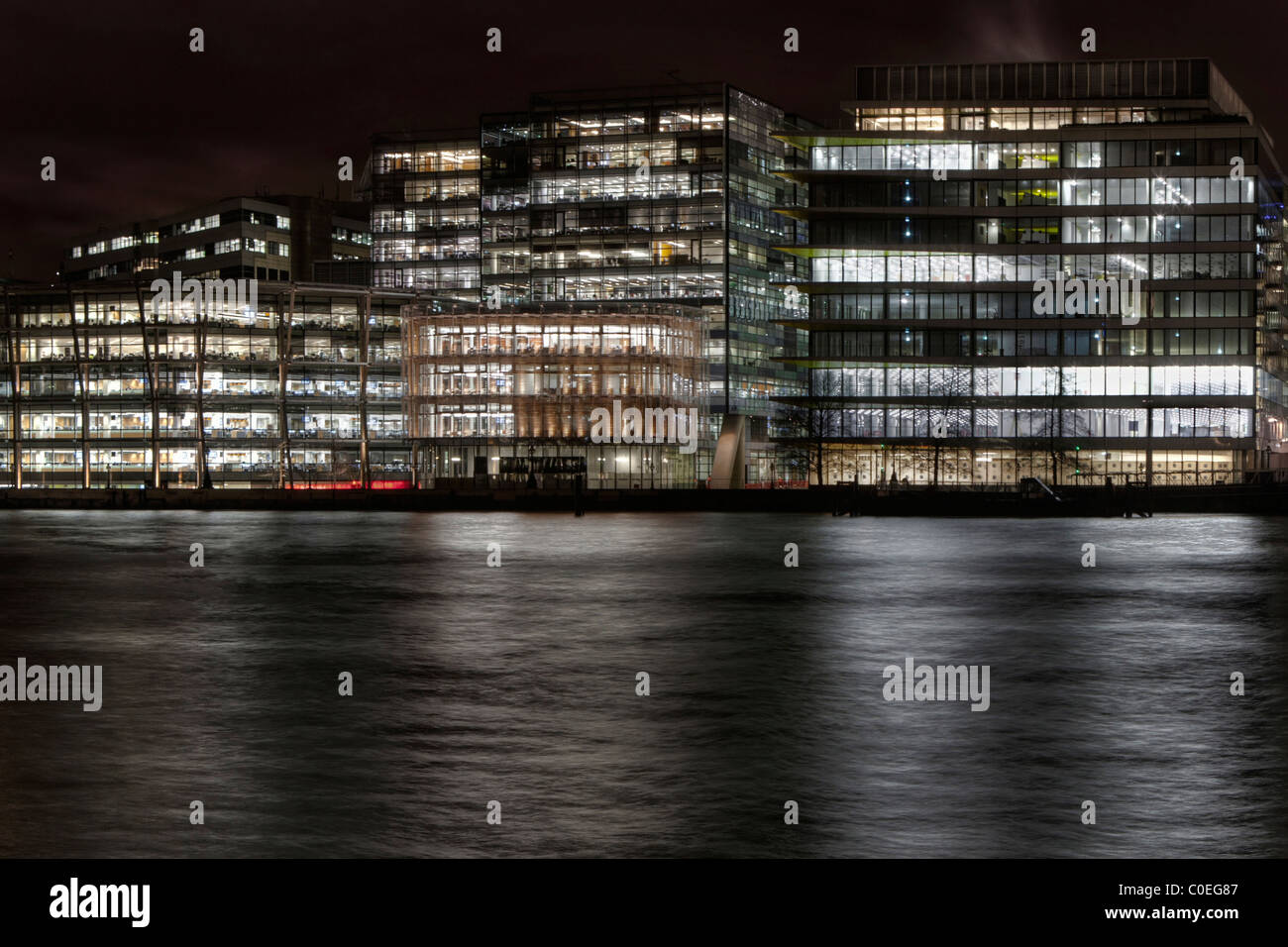 Office buildings in London at night as seen from across the Thames Stock Photo
