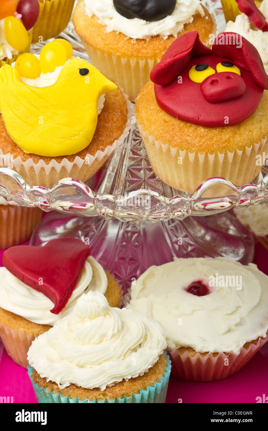 A variety of vibrant fun homemade cup cakes on cake stand. Stock Photo