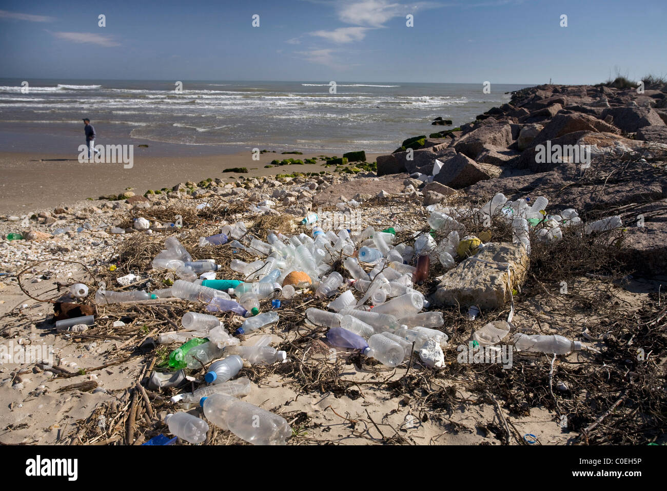 Trash litters the beach and jetties where the Mansfield Cut meets the Gulf of Mexico south of Corpus Christi, Texas Stock Photo