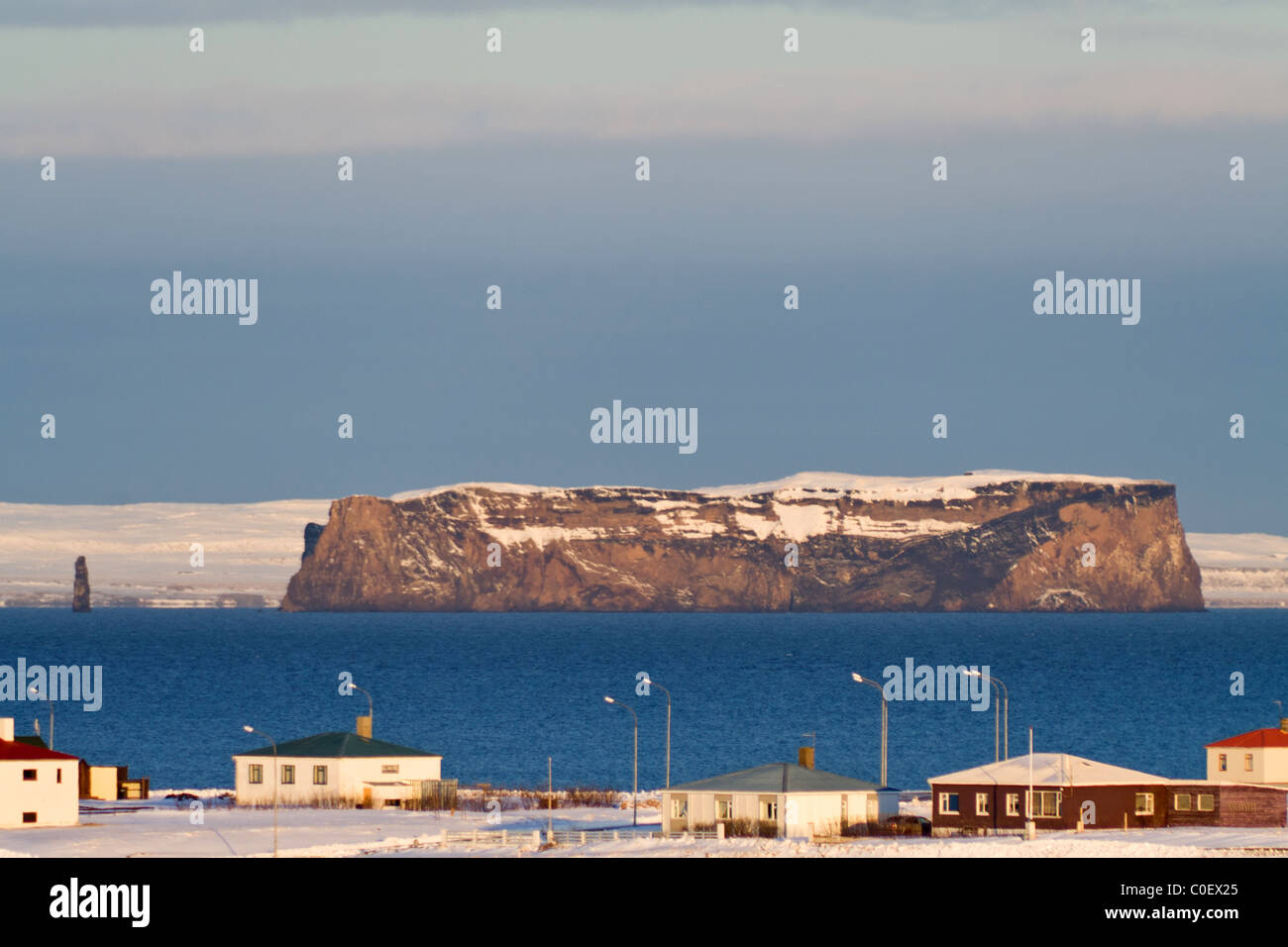 The island Drangey, outside Hofsos, Iceland, is lit up by the morning sun. Stock Photo
