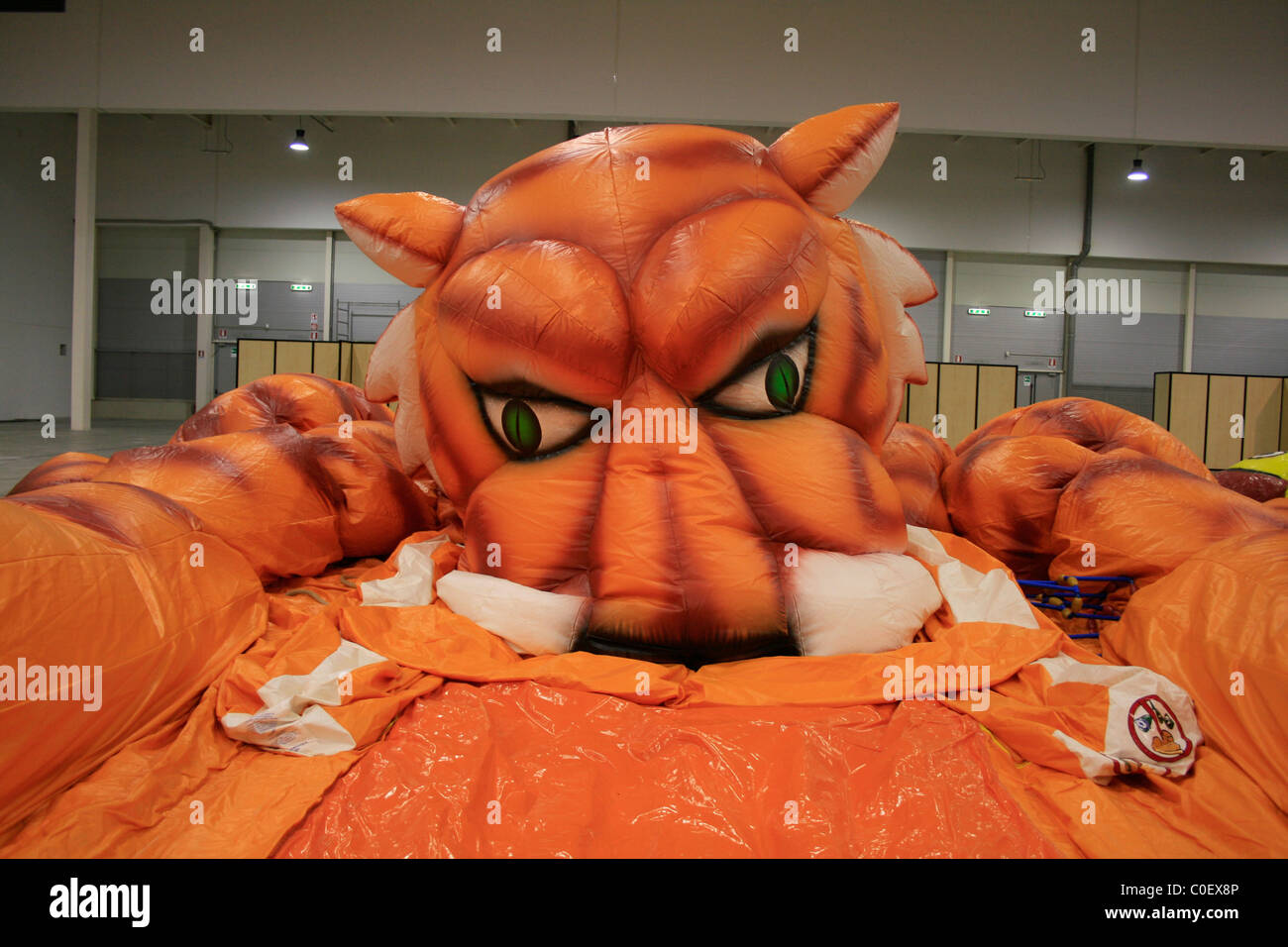 deflated tiger bouncy ride at trade event fair Stock Photo