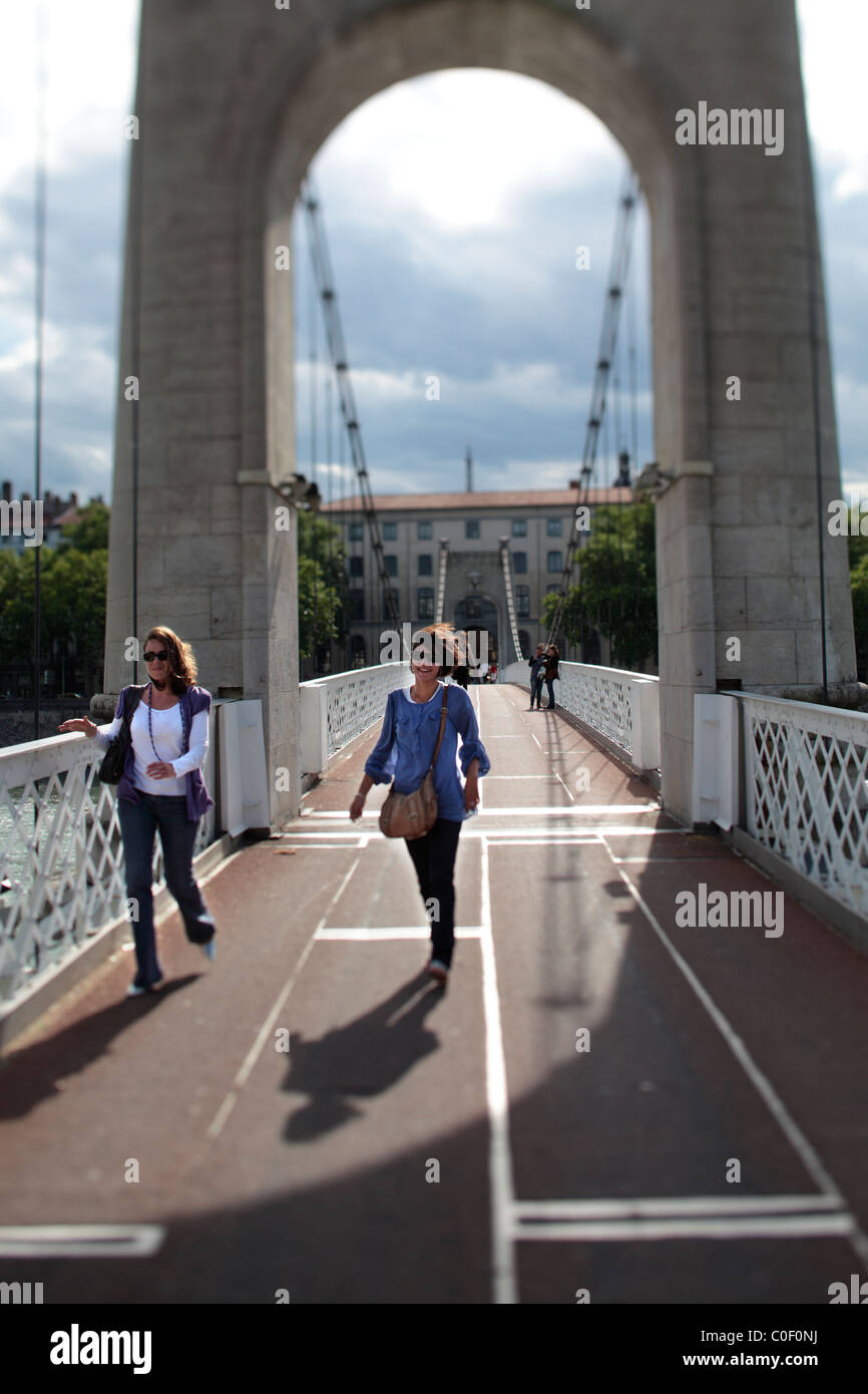 Walking across a bridge over the river in Lyon, France. Stock Photo