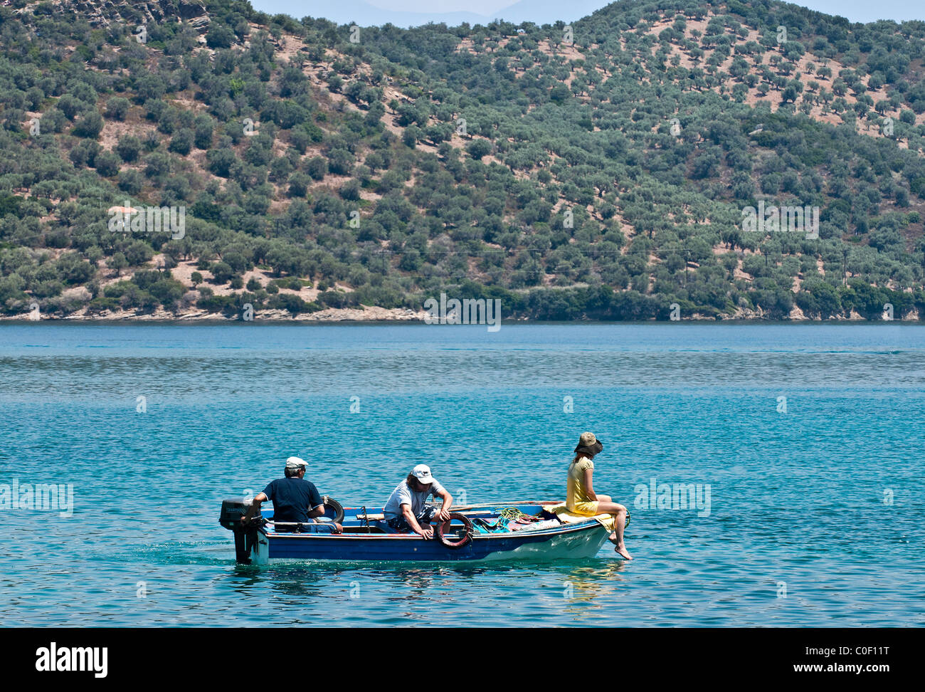 Greek Holiday makers on a boat, near the island of Paleo Trikeri on the southern coast of the Pelion Peninsula, Greece Stock Photo
