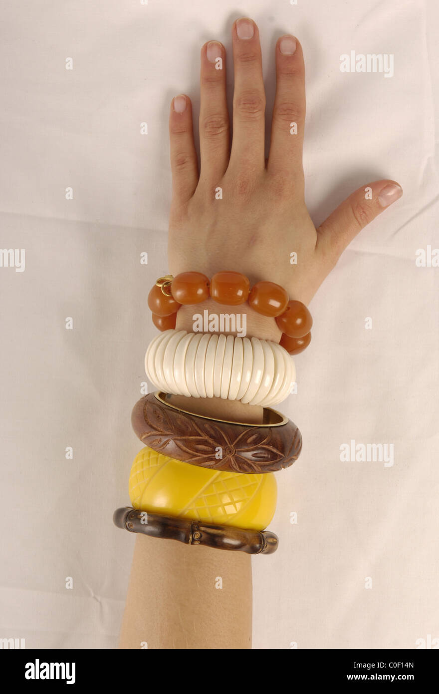 Young woman's arm wearing bracelets Stock Photo Alamy