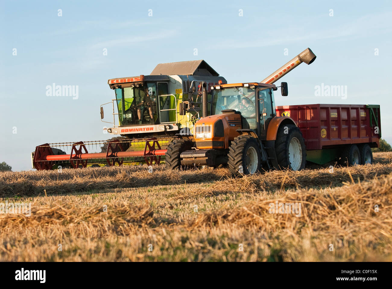 Combine harvester and tractor at work summer,Warwickshire, England