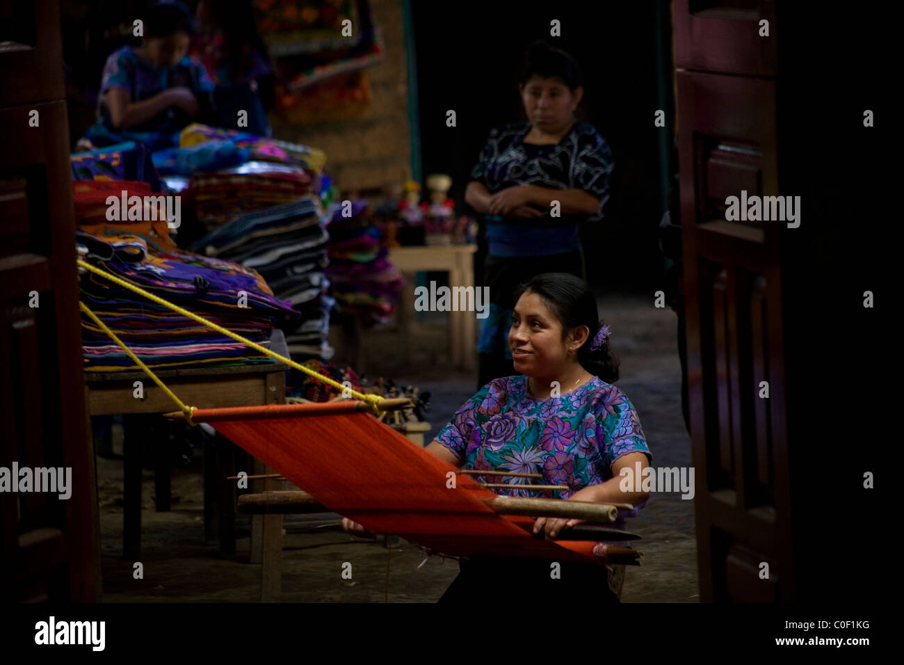 A Mayan Tzotzil woman weaves for tourists in a souvenir shop in Zinacantan, Chiapas, Mexico Stock Photo