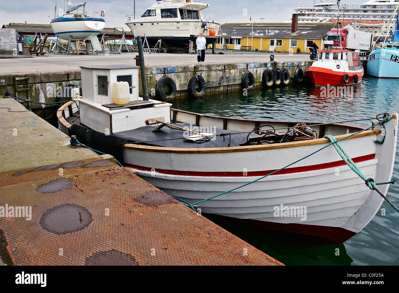 Fishing boats and the cruise ship Artemis moored in the port of Ronne