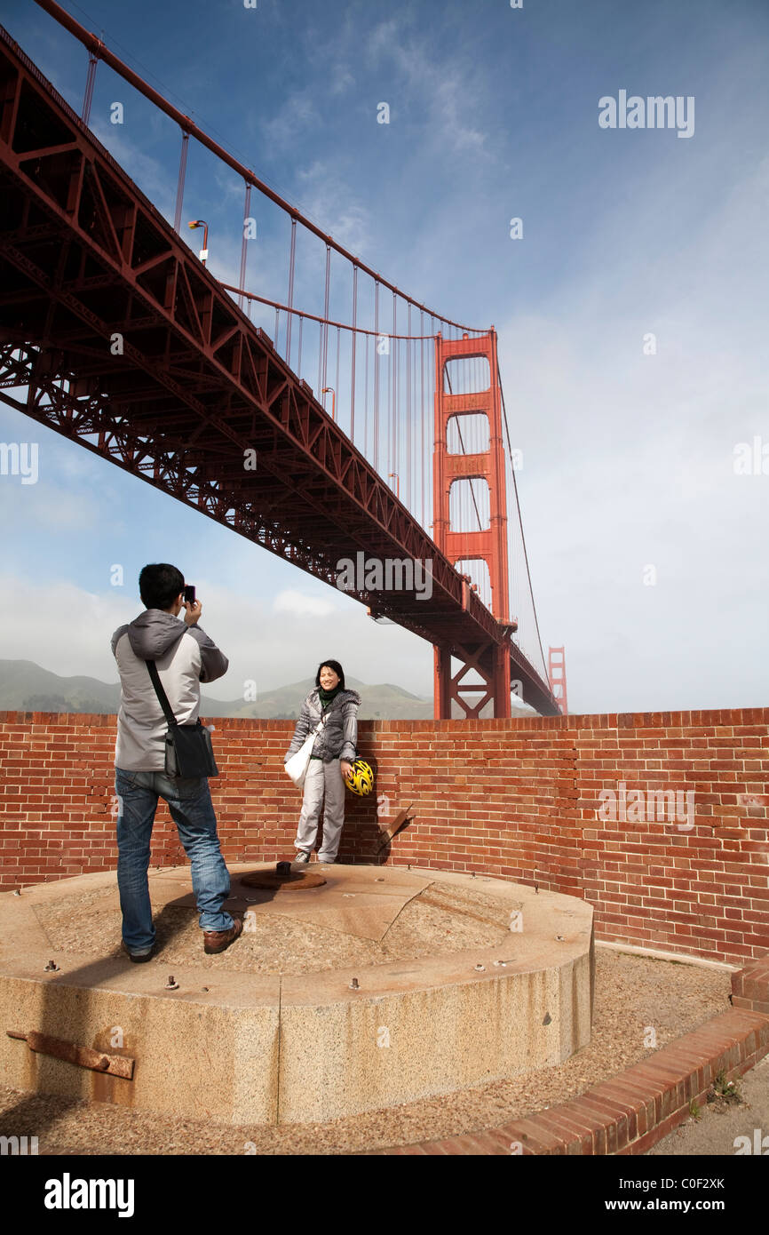 A young couple takes photos as they explore Fort Point in San Francisco. Feb. 2010 Stock Photo