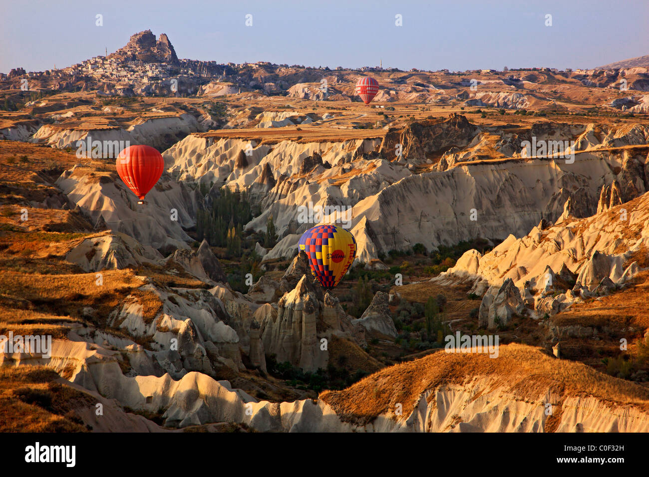 Hot air balloon flight above the Love Valley Cappadocia, Turkey. In the background, the natural castle of Uchisar town. Turkey. Stock Photo