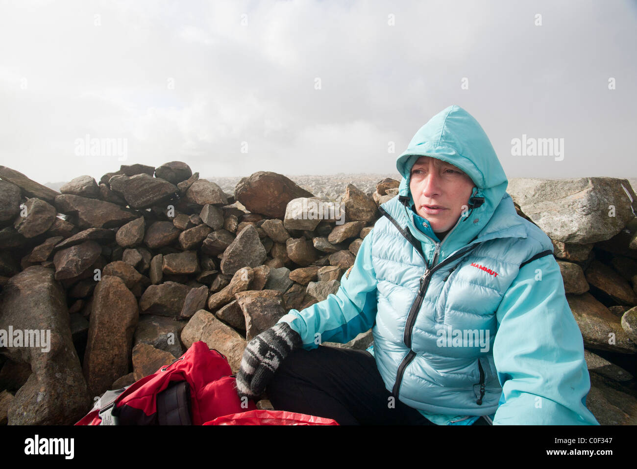A women fell walker on the summit of Fairfield in the Lake District, UK. Stock Photo