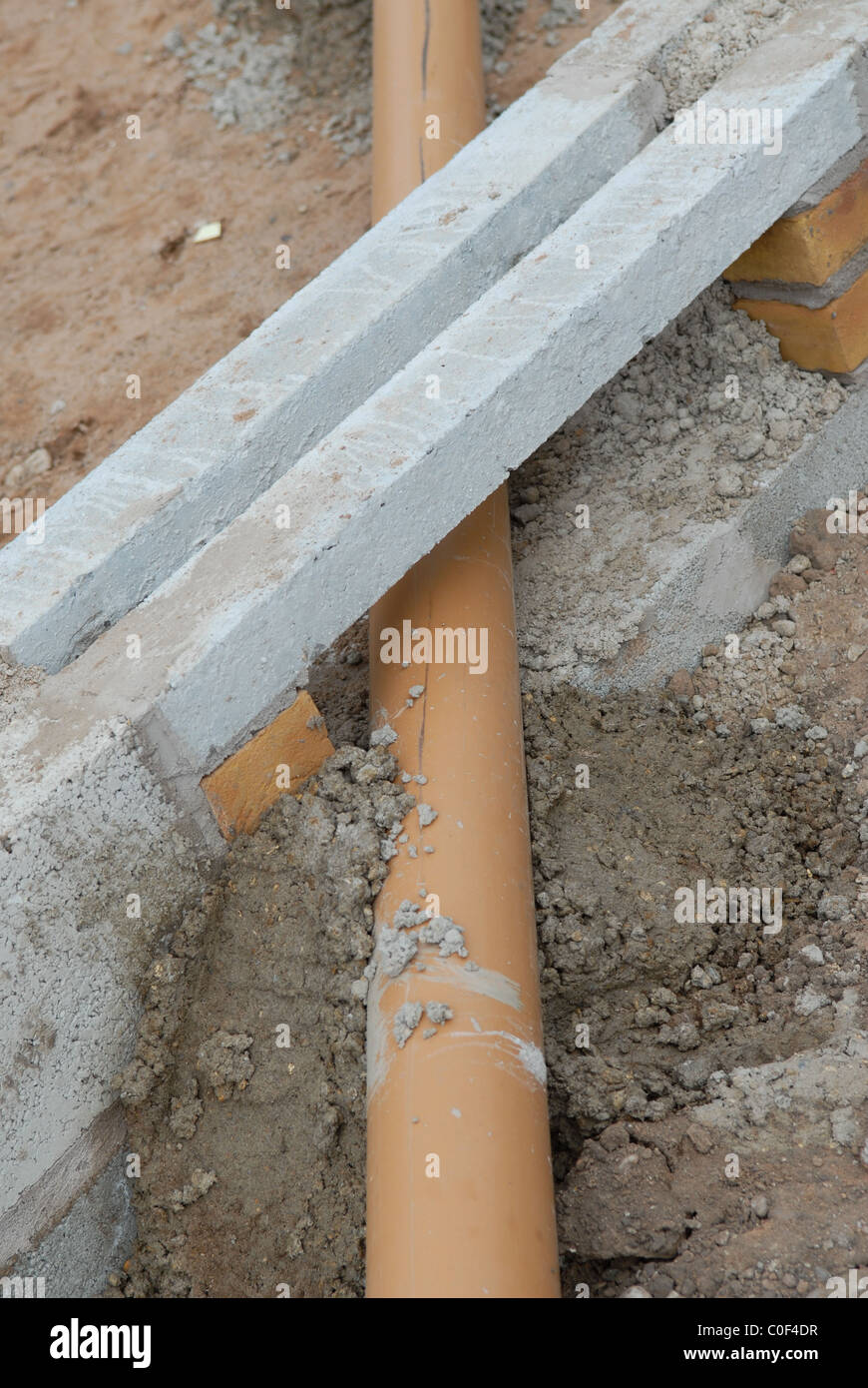 A concrete lintel placed over the new mains drain pipe Stock Photo Alamy