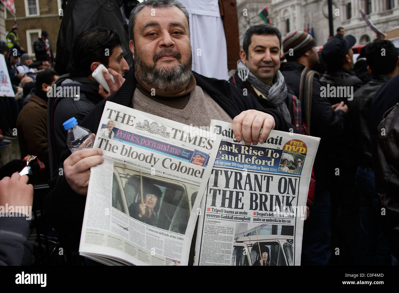 Libyan protester hold up newspapers showing media coverage Stock Photo