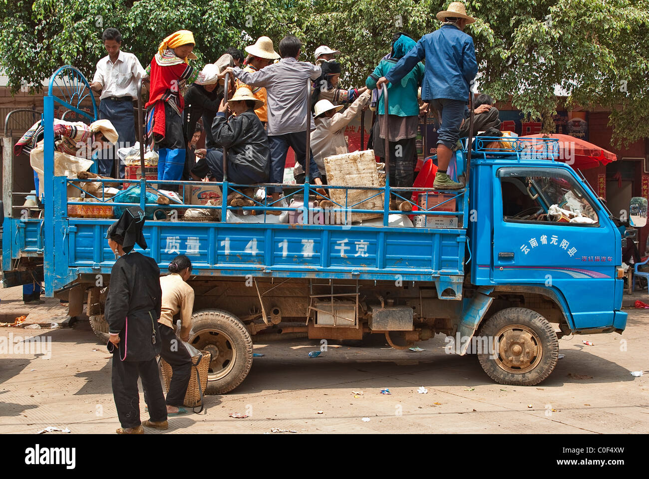 Asia, China, Yunnan, Honghe Prefecture, Jinping County, Laomeng Town. Hani, Yi and Yao people board truck at market. Stock Photo