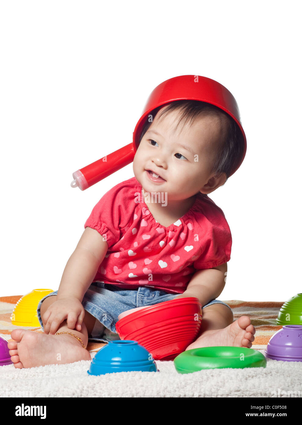 Playful Chinese toddler girl isolated on white background Stock Photo