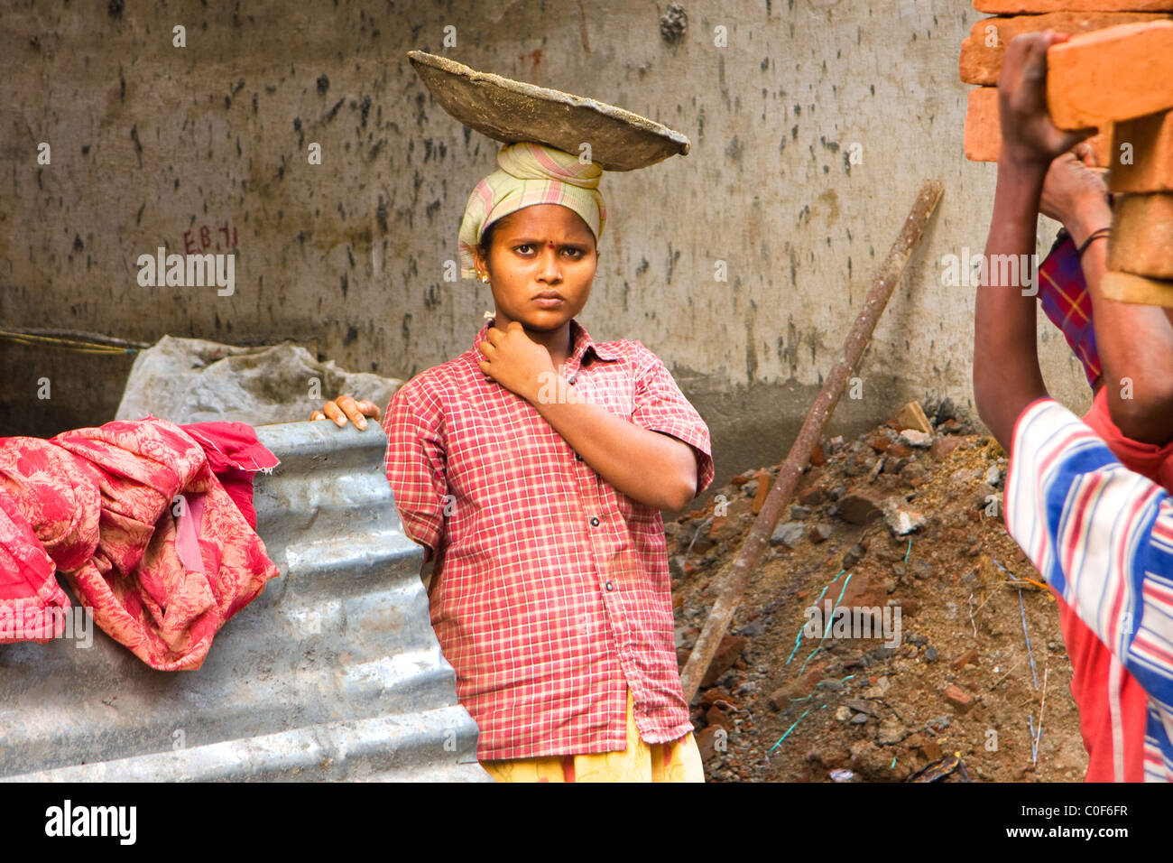 Young Indian builder girl with head tray. Stock Photo