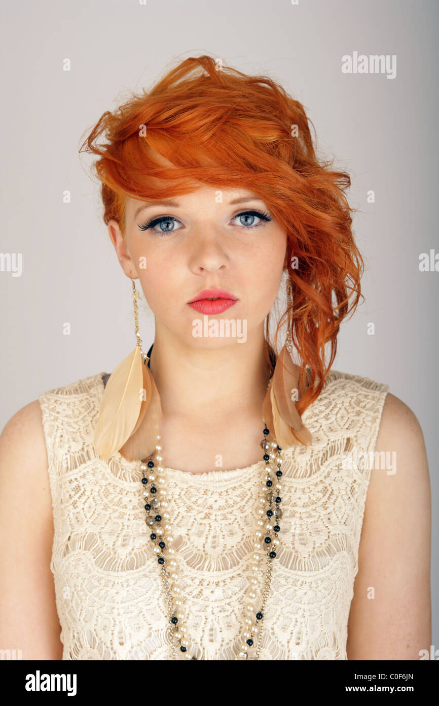 Beautiful teenage girl with orange hair looking forwards. Stock Photo