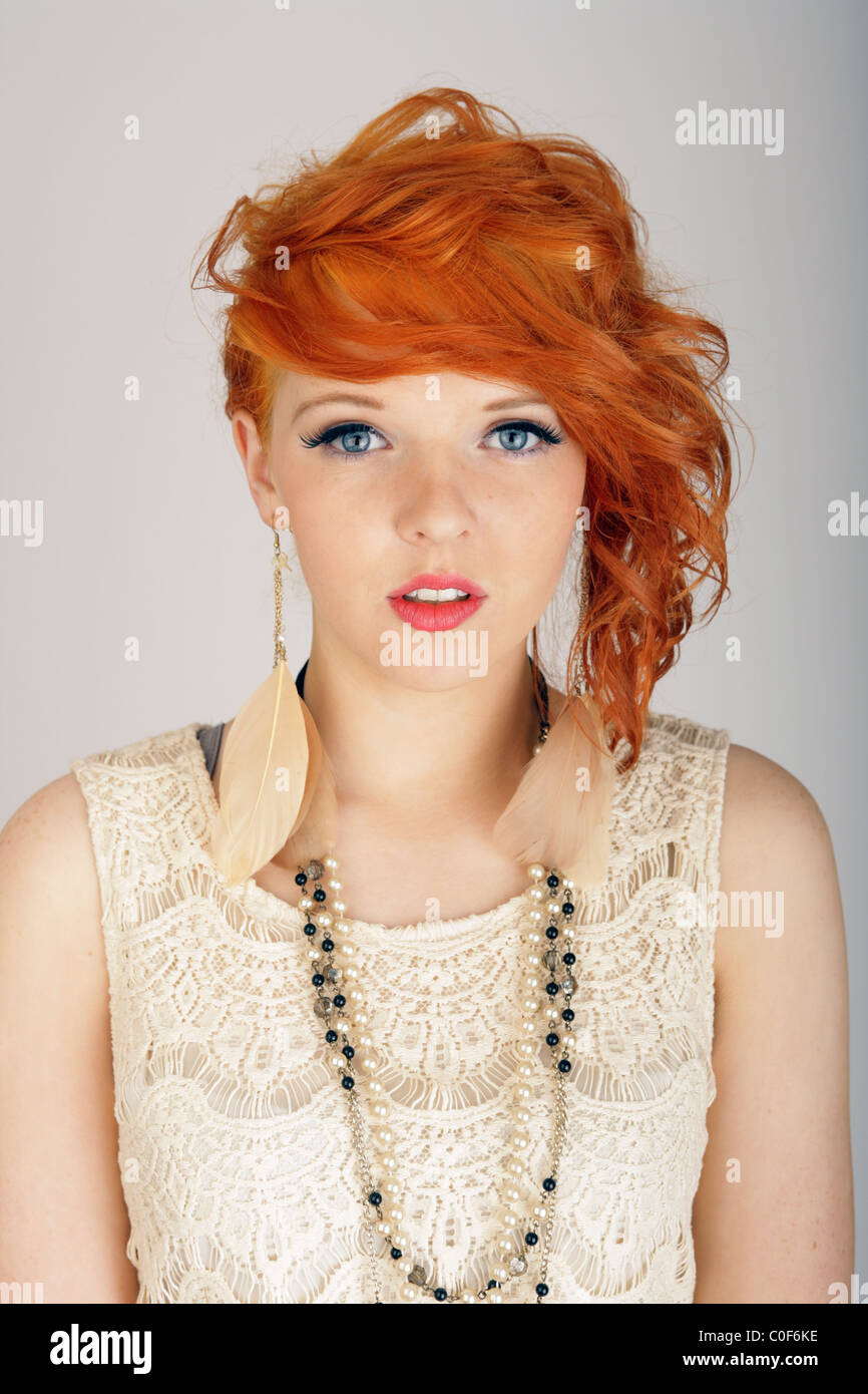 Beautiful teenage girl with orange hair looking forwards. Stock Photo