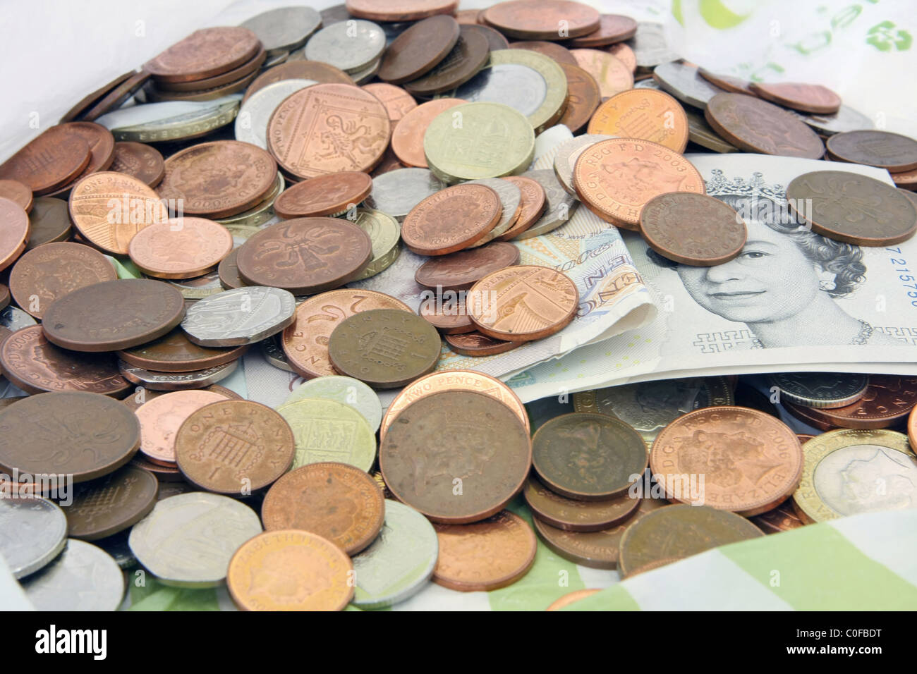 Looking into a plastic bag at a jumble of mixed denomination sterling