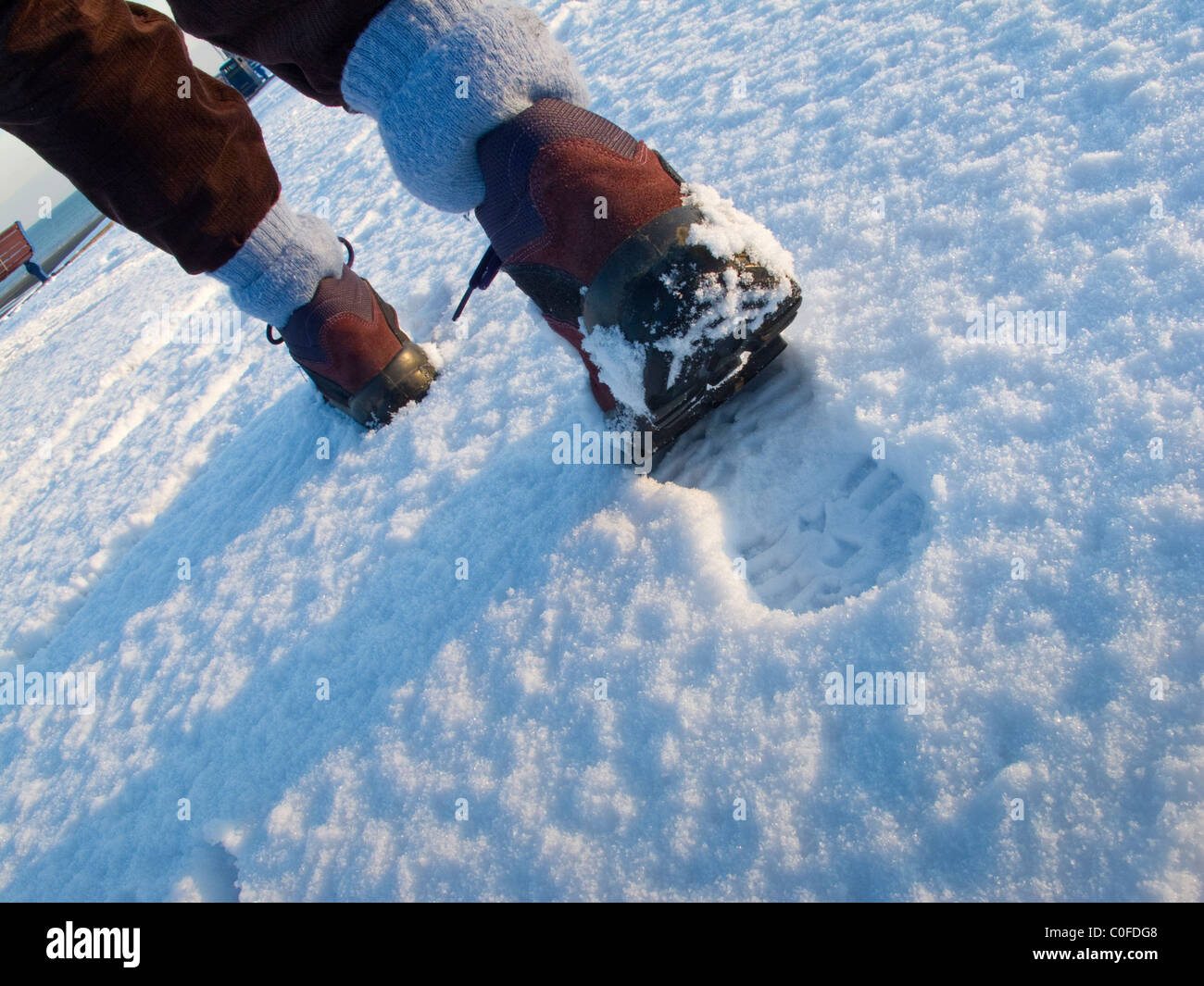 Shoes making footprints in the snow hires stock photography and images Alamy