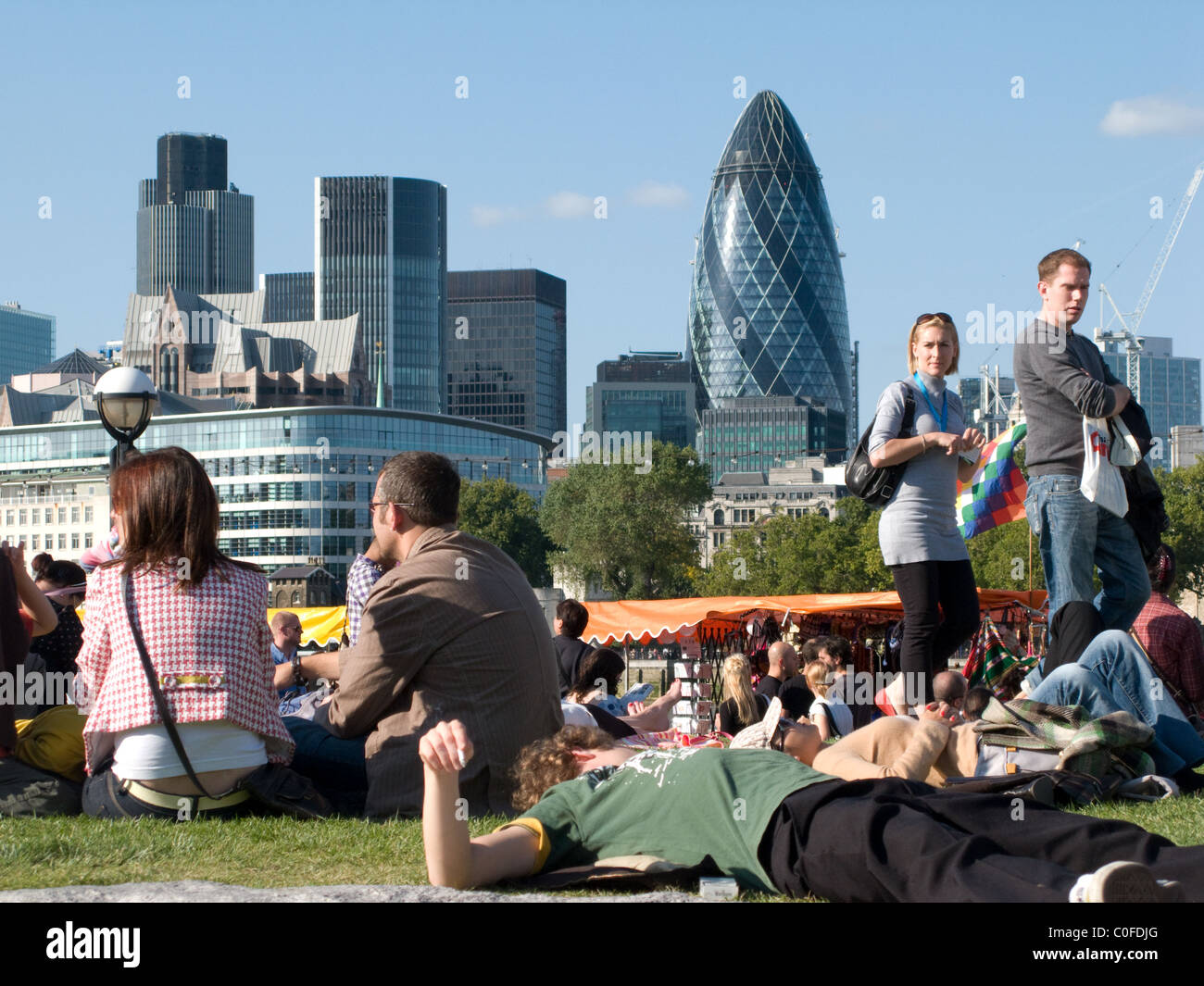 Festival goers at the Thames Festival, Potters Fields Park (by City Hall), London. The Gherkin in the background Stock Photo