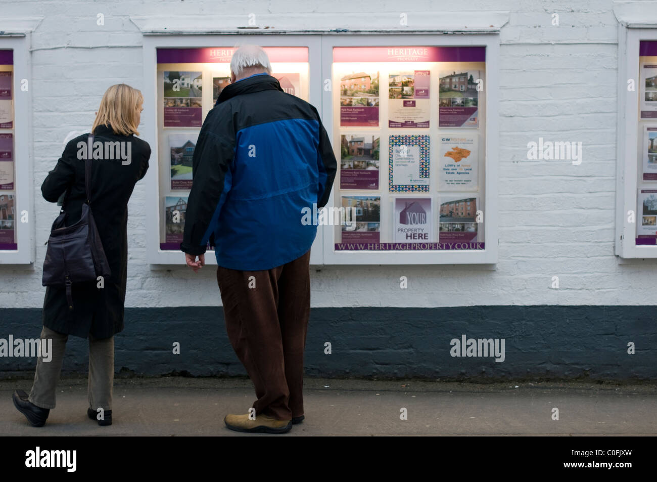 Man and woman looking at houses to buy in Kenilworth, Warwickshire. Stock Photo