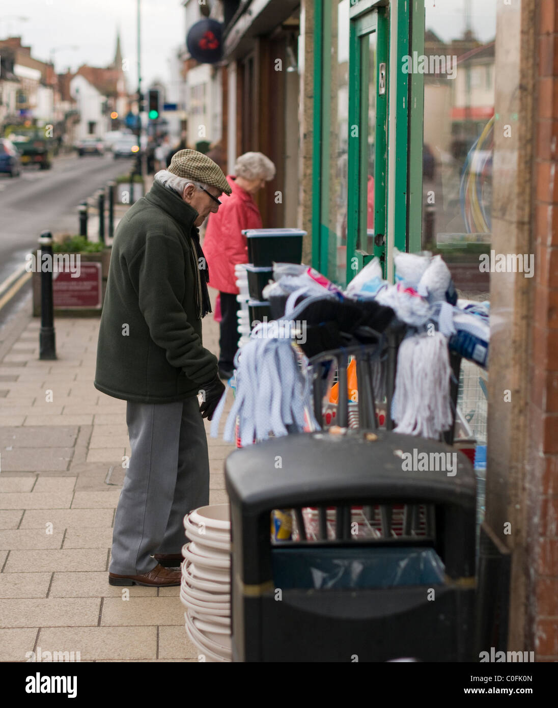 Elderly man shopping for household items in a 'pound shop' in Kenilworth, Warwickshire. Stock Photo