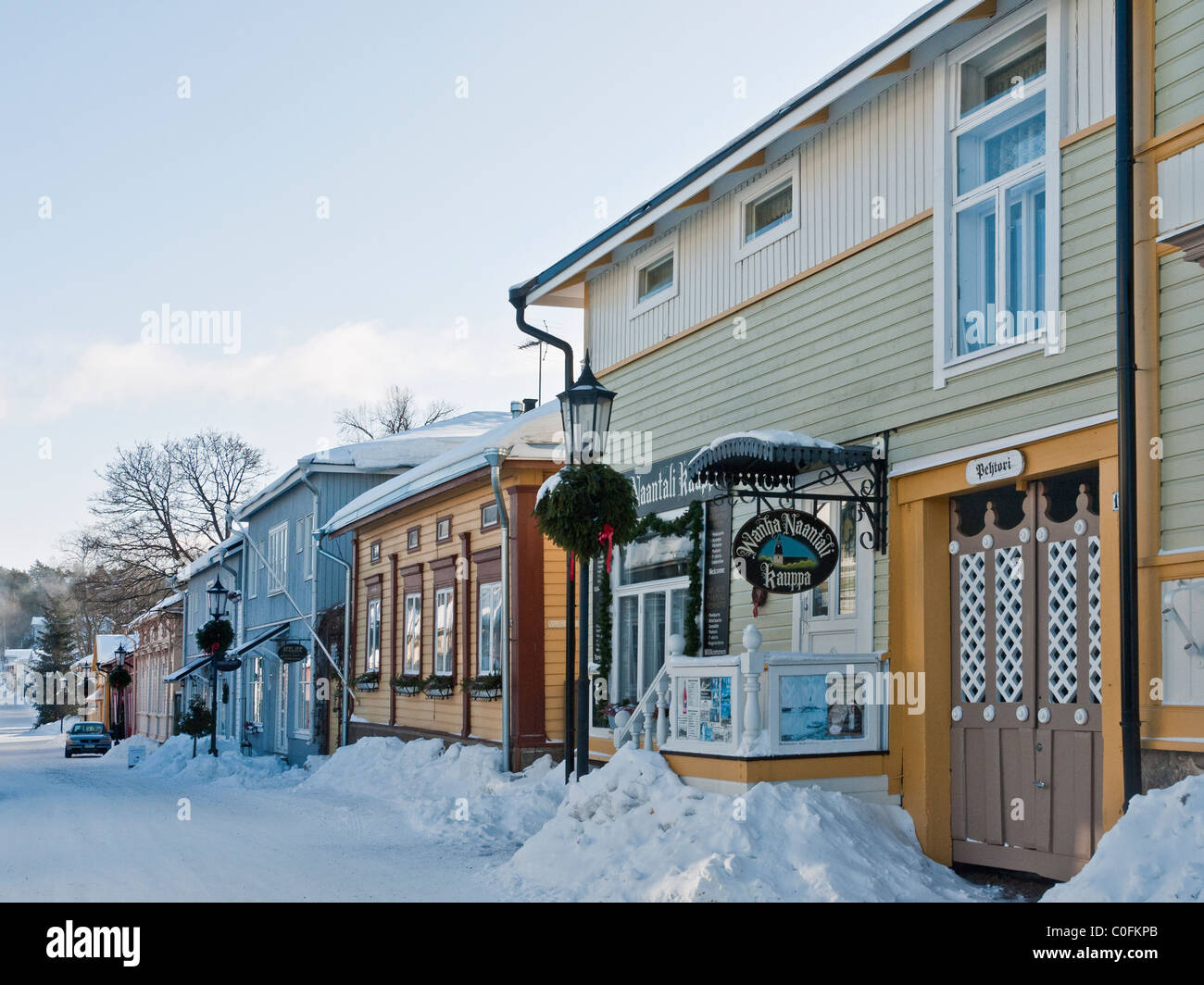 Traditional wooden buildings and shops on Mannerheiminkatu in winter snow, Naantali, South-western Finland Stock Photo