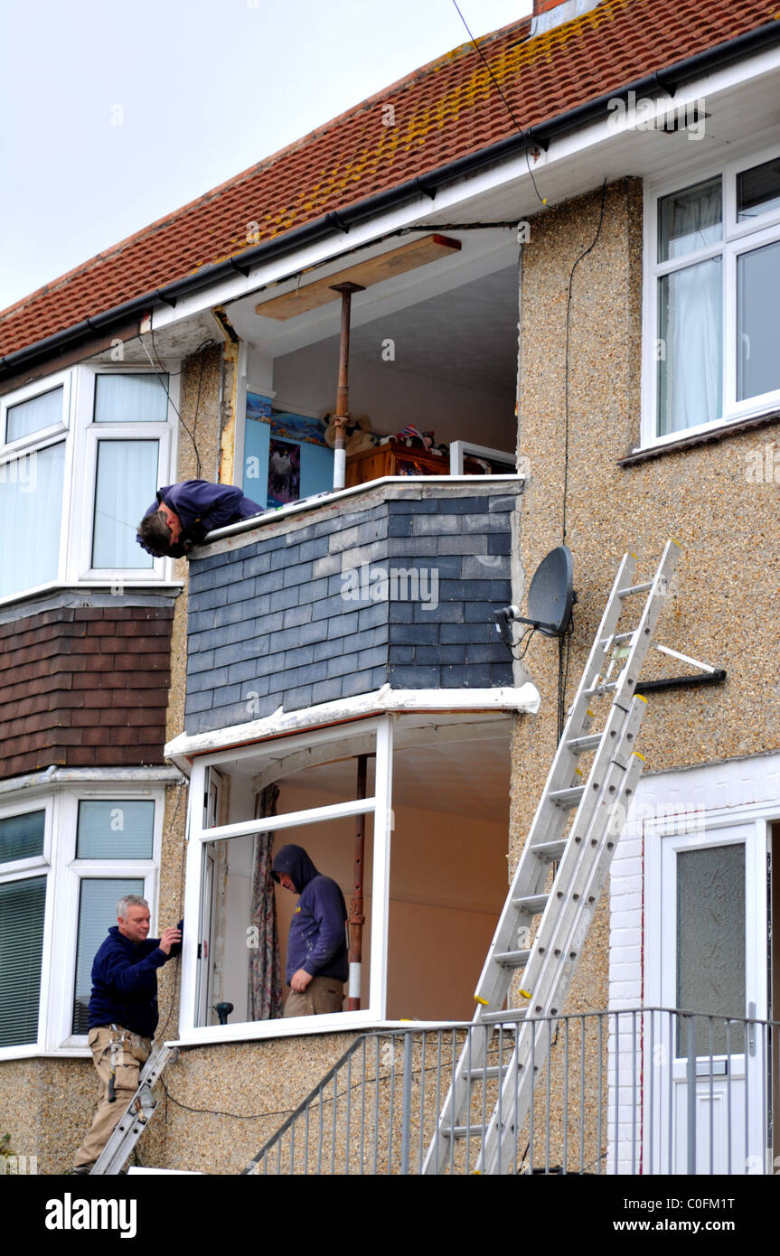 New windows being installed on a house, UK (only for use in positive stories on window replacement) Stock Photo