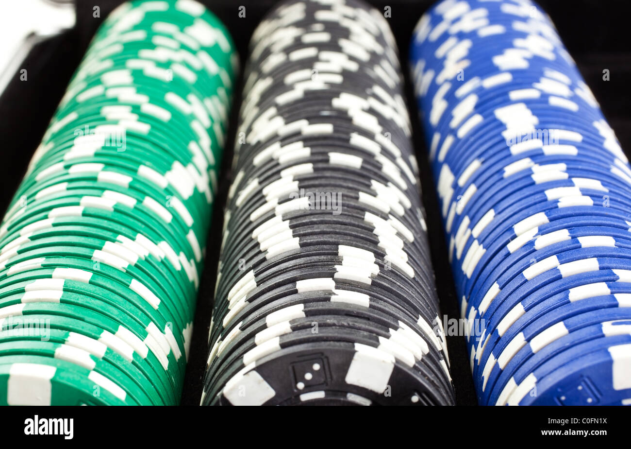 color poker chips heaps in black box. horizontal shot. another similar