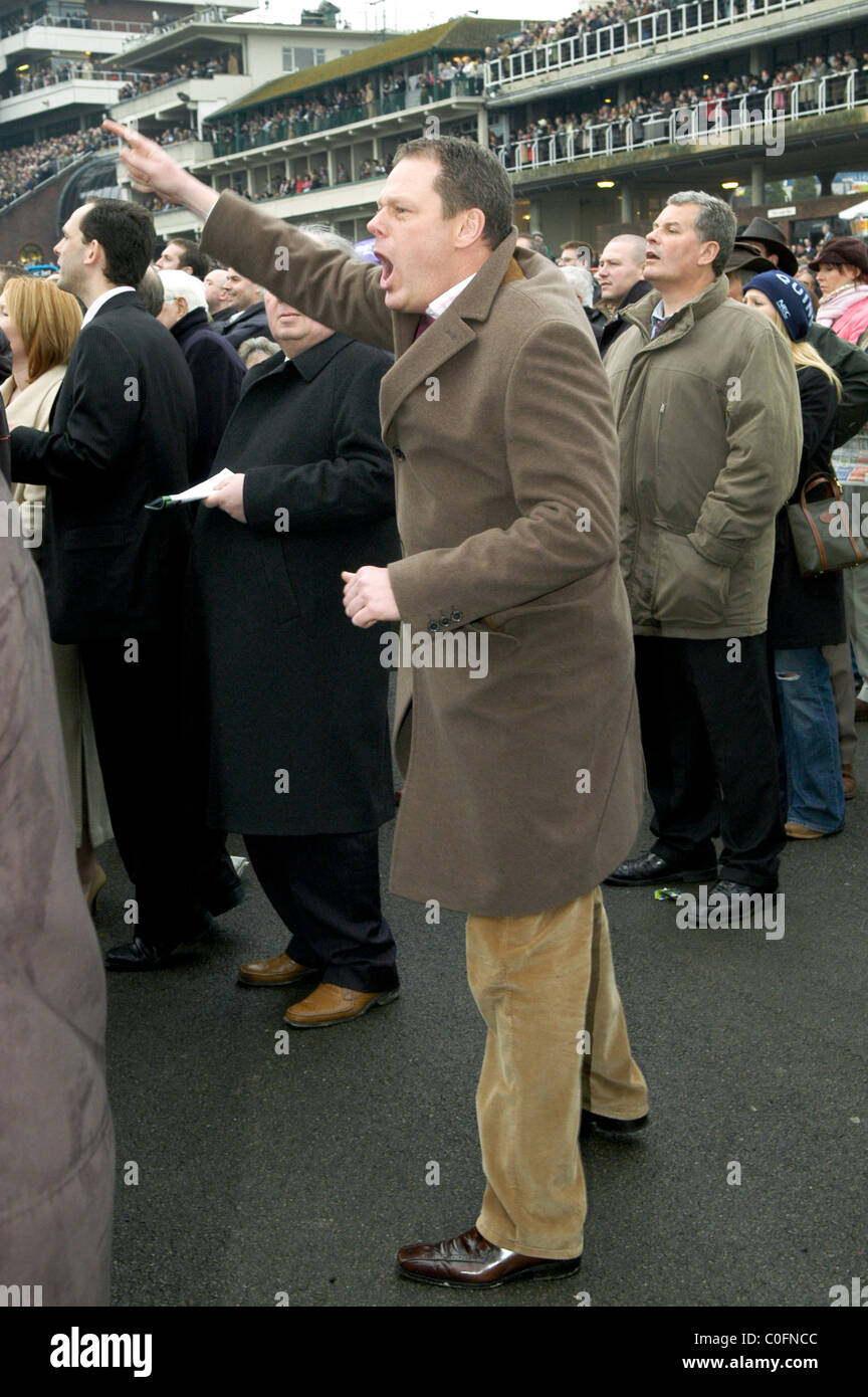 A man watching a horse race at Cheltenham Race course Stock Photo