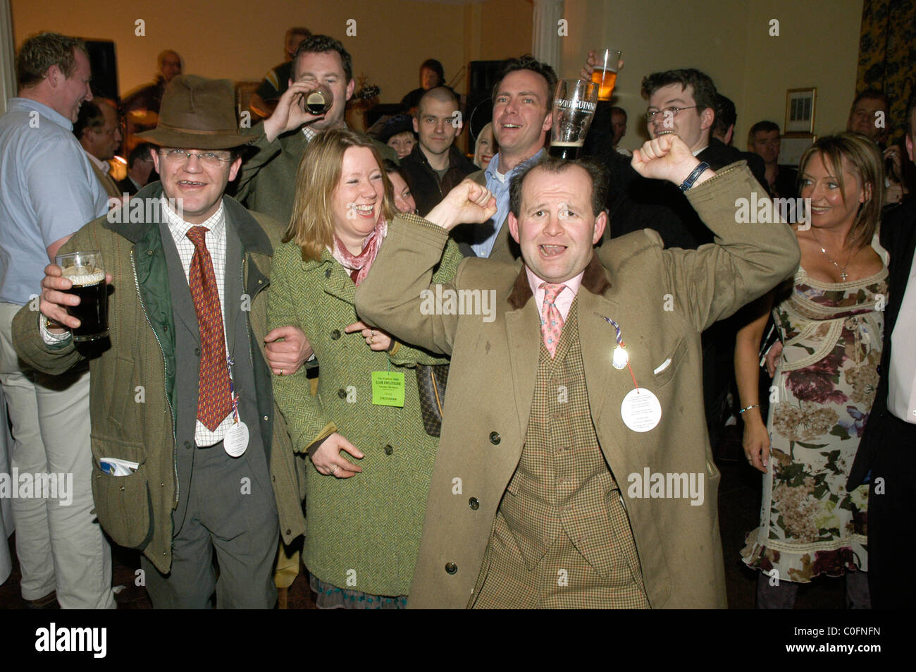 Drinkers enjoying themselves after a day at Cheltenham Horse racing at The Queen Hotel. Stock Photo