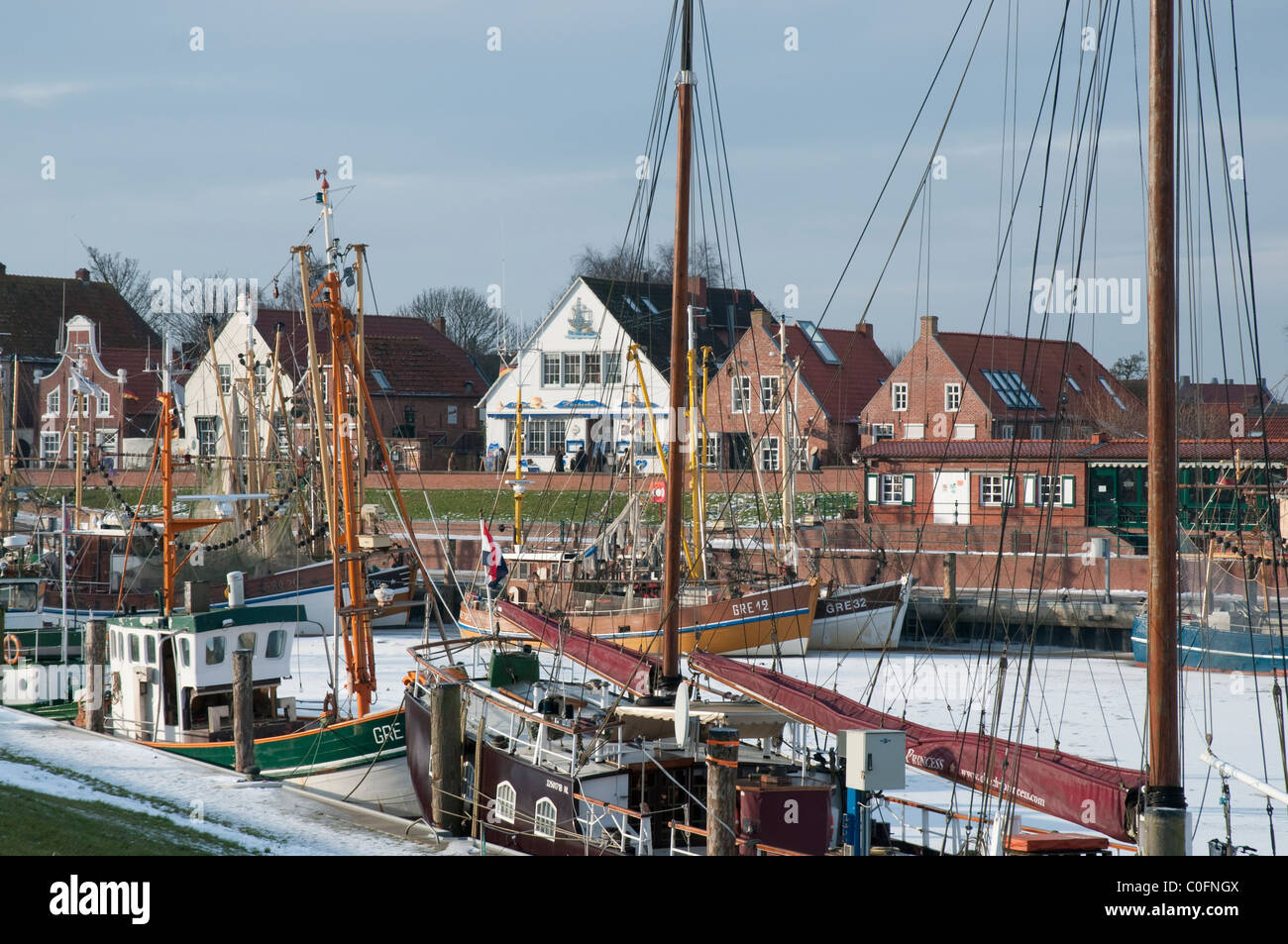 harbour of Greetsiel with fishingboats,  in the background the Sielstreet, East Frisia, Northsea Stock Photo